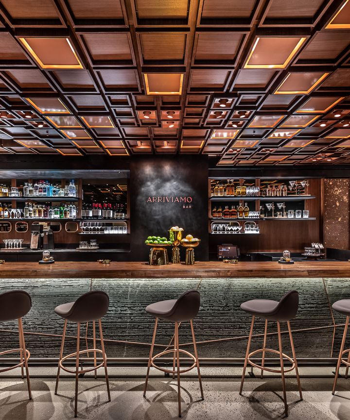 The custom walnut ceiling frames this bar perfectly