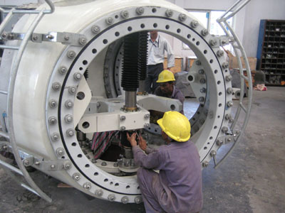 Final adjustments and testing of the hydraulic pitch control mechanism for the windmill blades.