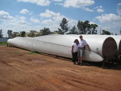 Mark and Teresa in front of three 77 foot long blades ready for shipment at the LM blade fatory in Bangalore, India