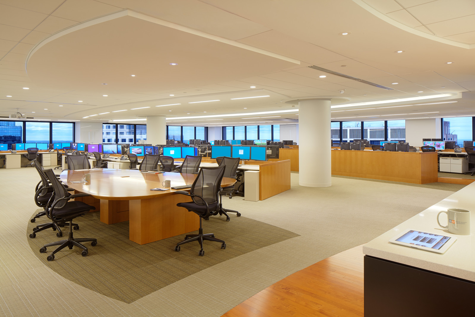 These custom wood workstations and conference table make for a modern but effective collaborative space.  