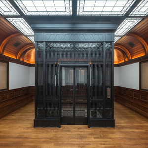  Tongue-and-groove planked vaulted beamed ceilings, wainscotting and wood benches make this elevator lobby truly unique.