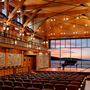 The glass wall rises behind the stage to reveal a breath-taking stretch of the Atlantic Ocean.