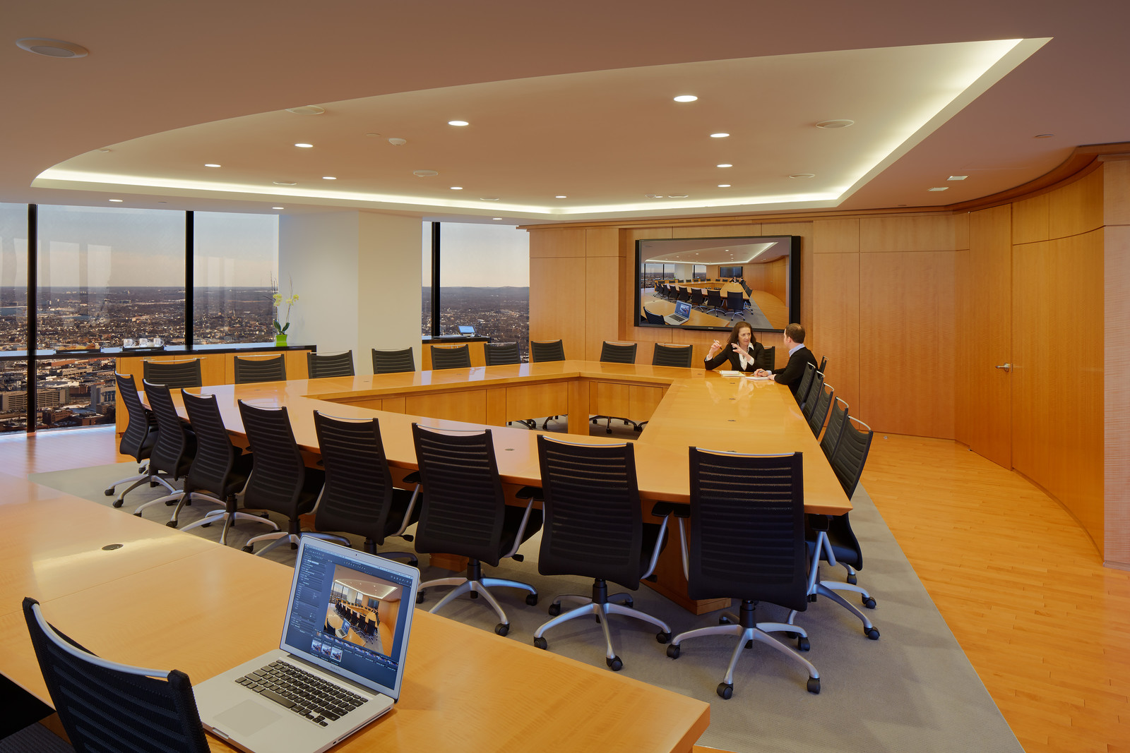 We crafted a custom conference table and furniture and matched it to figured anegre paneling and millwork. This room is both breathtaking and warm.