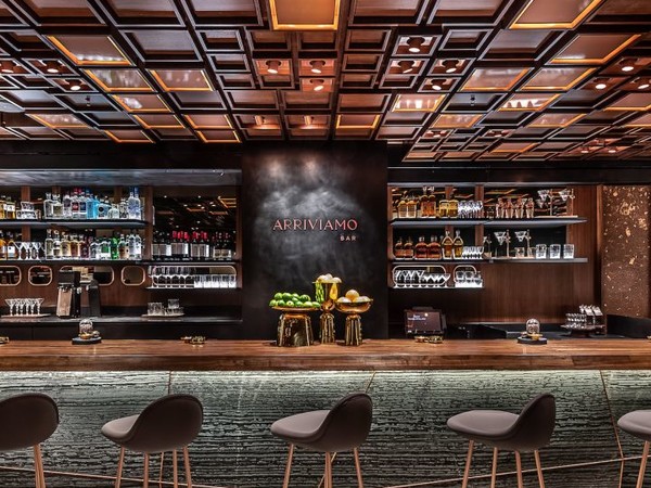 The custom walnut ceiling frames this bar perfectly