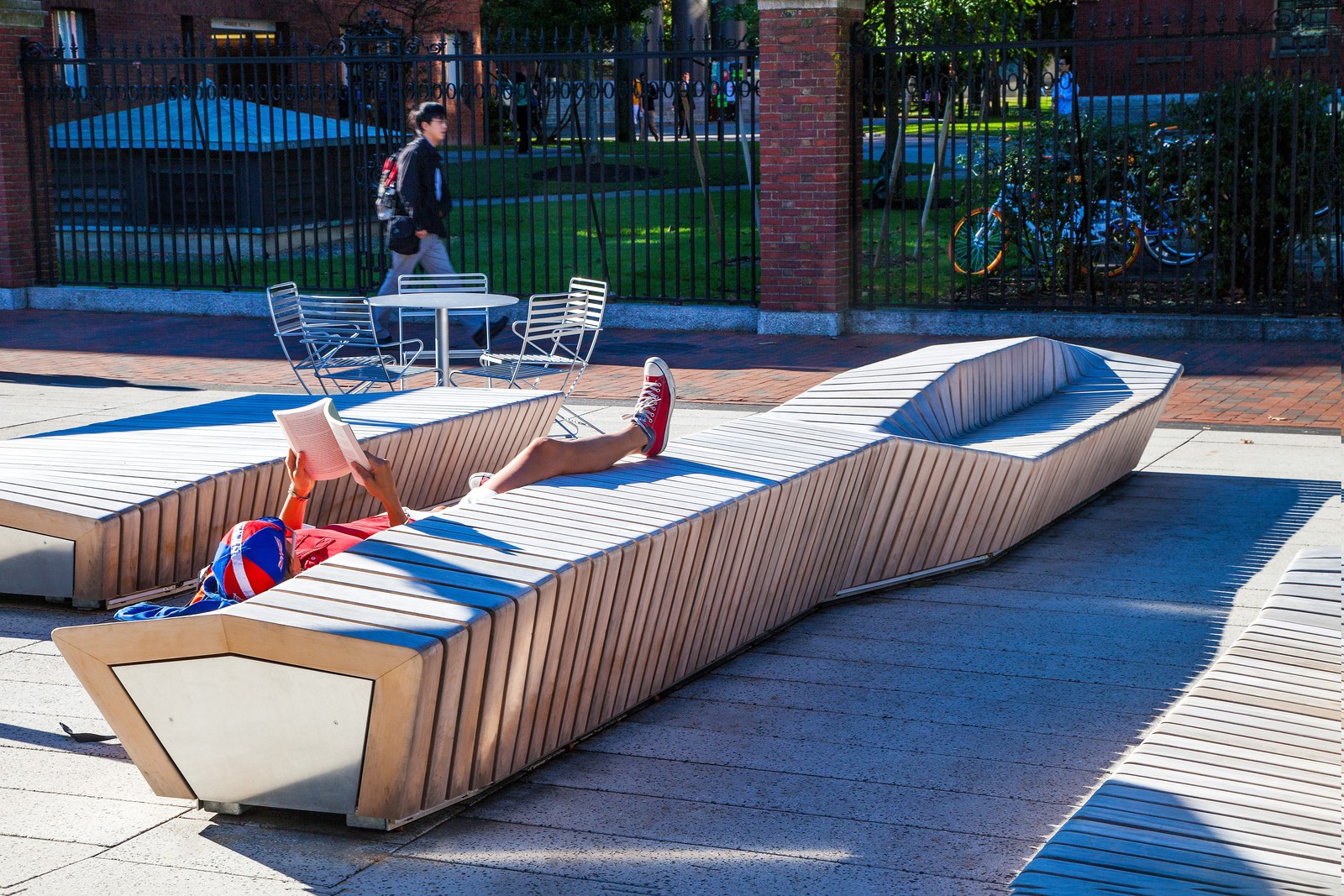 Relaxing on these beautifully crafted Harvard University benches. The wood makes them comfortable and the unique design make these benches the centerpiece of Harvard University Plaza.