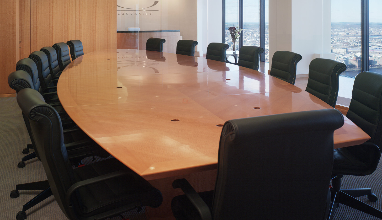 Gorgeous custom wood conference table with matching wall panels for a client in downtown Boston