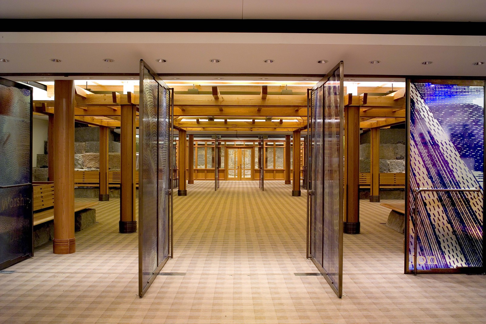Wood wrapped columns and glass doors make this a welcoming and interesting space.