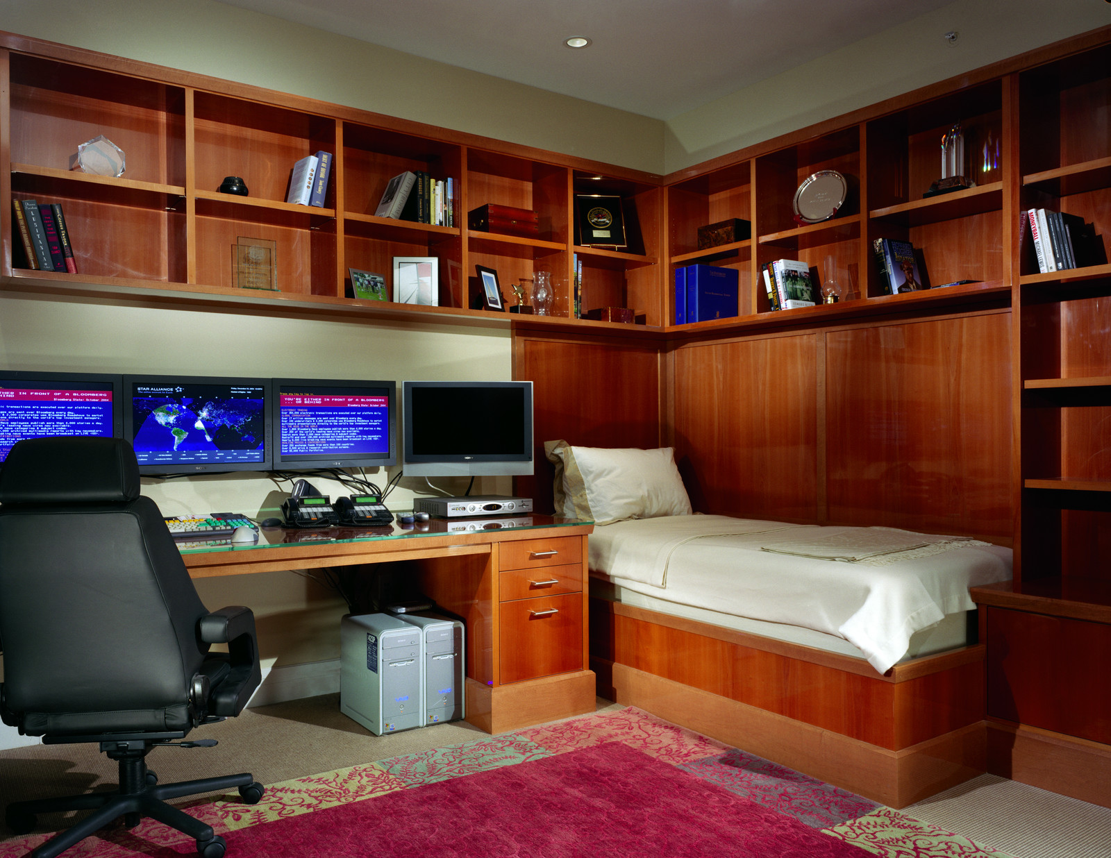 This custom built office/bedroom makes the best use of all the space. The woodwork makes the room!