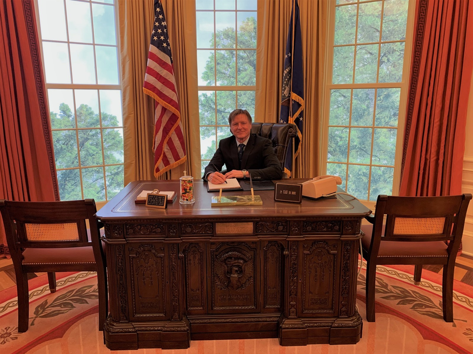 Mark Richey at the Resolute Desk at the opening of the exhibit 2020