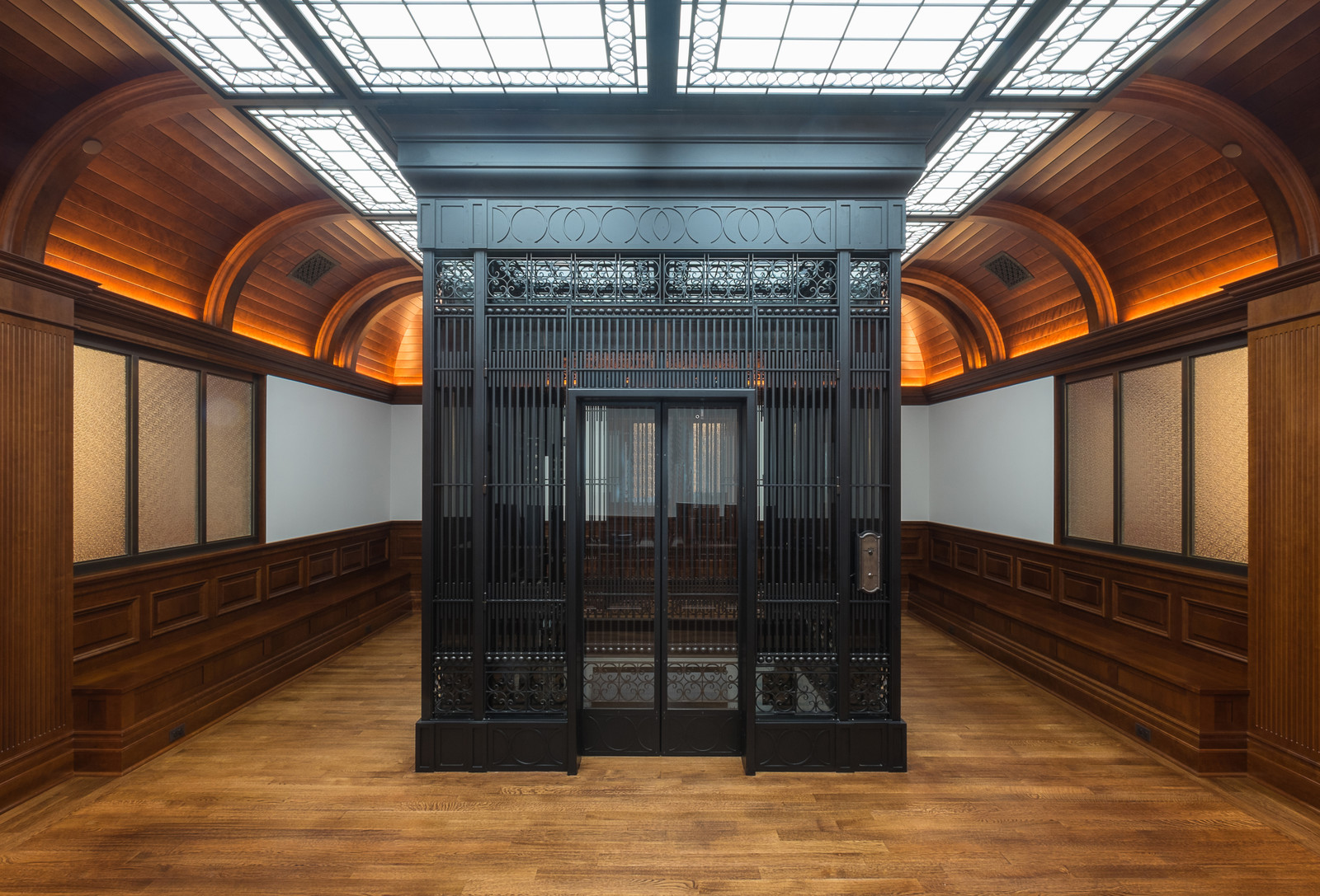  Tongue-and-groove planked vaulted beamed ceilings, wainscotting and wood benches make this elevator lobby truly unique.